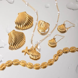 Marine jewelry set with shell and starfish charms in gold finish and white pearls