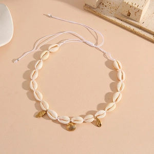 Detail of adjustable natural cowrie shell necklace with gold starfish and leaf charms
