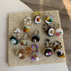 Retro beaded ring set with colorful resin charms and elastic bands on stone board