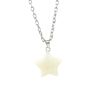 Macro shot of a pentagram natural crystal pendant on a silver metal chain necklace