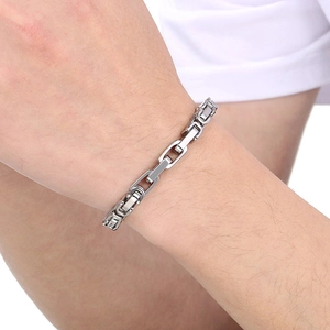 Detail of 6mm stainless steel Byzantine chain bracelet on a male wrist with metallic luster