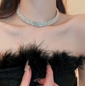 Close-up of elegant silver tiered rhinestone choker necklace worn by a model