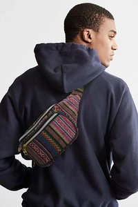 Close-up of a colorful Bohemian woven waist bag with ethnic patterns on a male model