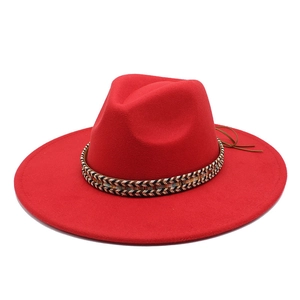 Close-up of red felt fedora with woven tricolor band and brown leather drawstring