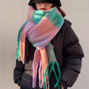 Close-up of a long rainbow plaid knit scarf with soft tassels and mohair texture