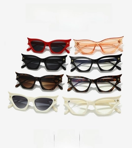 Macro shot showing retro Y2K cat-eye sunglasses frames in eight trendy color variants