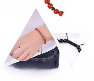 Detail of red agate Morse code bracelet with black cord and adjustable pull string