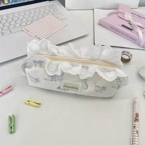 Detail of white cotton cat pencil case featuring elegant lace trim and branded woven label