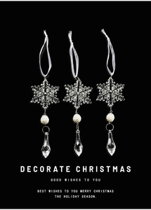 Detailed view of clear acrylic snowflake ornaments with pearls on black background