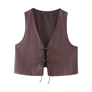 Detail of dark brown pleated V-neck vest top with stylish tie-up ribbon closure