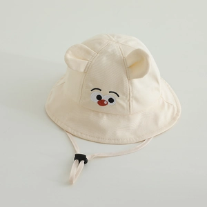 Detail of baby sun hat with embroidered cartoon face and adjustable chin strap