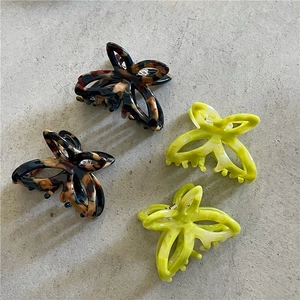 Detailed set of four butterfly hair claws in leopard print and bright lime green acetate
