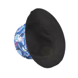 Close-up of reversible bucket hat featuring tropical toucan print and black interior side