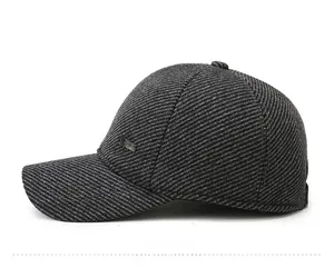 Detail view of dark grey twill fabric texture and small metal logo on baseball cap