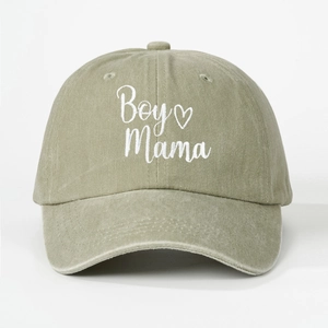 Detail view of white Boy Mama embroidery on olive green washed cotton baseball cap