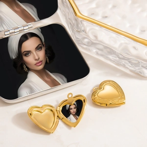 Detailed view of open and closed heart-shaped gold locket pendant with photo insert