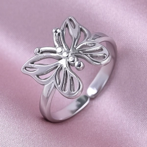 Detailed close-up of hollow butterfly ring in polished stainless steel with adjustable band