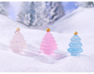 Miniature pastel Christmas trees with golden stars on a realistic snowy surface background