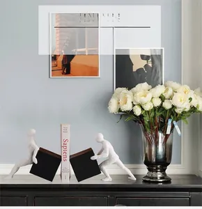 Close-up of minimalist resin human figures pushing cubes as creative bookends decoration