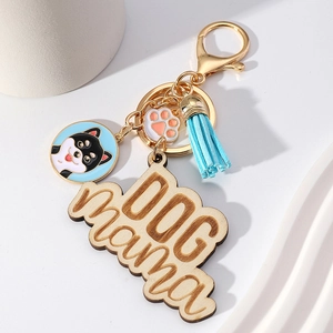 Dog Mama wood keychain with Shiba Inu pendant and blue tassel on decorative background