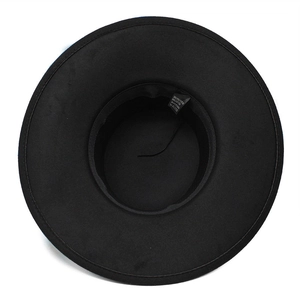 Detail of black wide-brim hat interior with adjustable strap and material care label