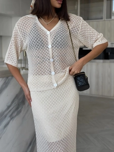 Detailed close-up of intricate hollow knit pattern on apricot crochet skirt set for women