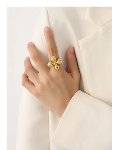 Detailed close-up of 18k gold plated abstract floral ring with spherical petals