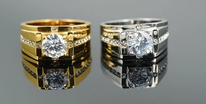 Detail view of gold and silver men titanium rings with large round cut center stone