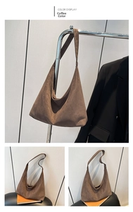 Detail view of large coffee brown suede tote bag with wide shoulder strap on a hanger
