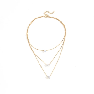 Three-layer gold necklace featuring delicate heart pendants and rhinestone charms on white background