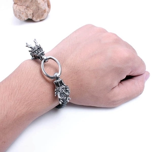 Hip hop leather bracelet featuring silver metal dragon heads on a white background