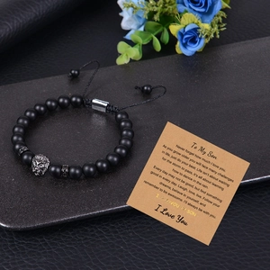 Detail view of lion head bead bracelet with matte black stones and To My Son message card