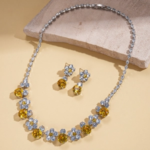 Detailed shot of jewelry set featuring yellow zircon flower pendant and matching earrings