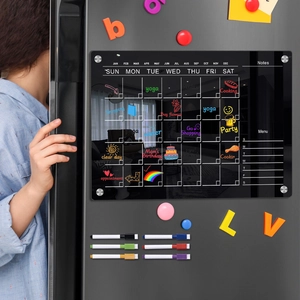 Magnetic acrylic weekly calendar set with colorful markers on a gray refrigerator