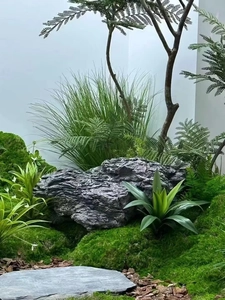 Detailed realistic artificial moss lawn with synthetic rocks and mixed greenery plants