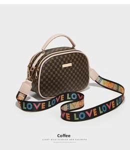 Detail of coffee printed shell bag with LOVE embroidered wide strap and double zipper