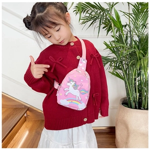 Girl wearing a pink unicorn chest bag with adjustable strap in a home setting