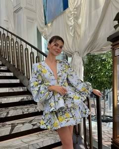 Detailed view of blue floral dress featuring deep V-neck and puff long sleeves design