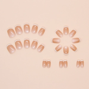 Detailed flat lay of 24 classic short square french press-on nails in nude pink and white