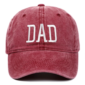 Close-up of white DAD embroidery on a vintage washed burgundy cotton baseball cap