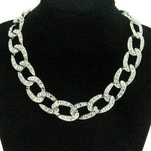 Detailed view of silver chain necklace with inlaid clear crystals on a black velvet mannequin