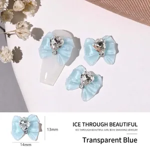 Macro view of 13mm translucent blue resin bow nail charm with central heart crystal