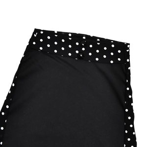 Detail of waist design with double buttons on black and white polka dot halter dress