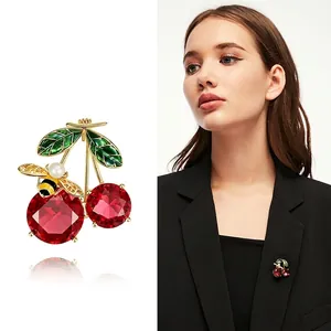 Red crystal cherry and bee brooch with pearls, shown on model and close-up view