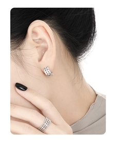 Macro view of honeycomb silver earring and matching ring with micro-paved zircons