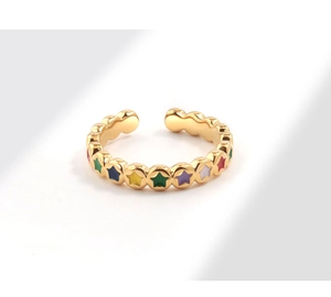 Close-up of gold star ring with colorful enamel inlay and adjustable open band design