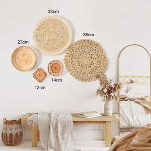 Detailed view of 5-piece set of woven seagrass wall baskets in varied bohemian patterns