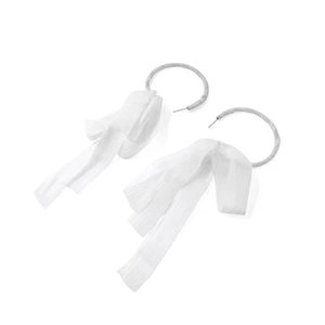 Detail view of handmade white chiffon bow earrings with round silver needle hoop design