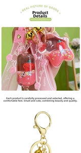 Detail of acrylic strawberry floating keychain with pink liquid sand stars and lucky strap