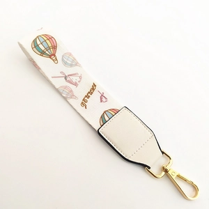 Macro detail of handbag strap with hot air balloon pattern and Flower embroidery